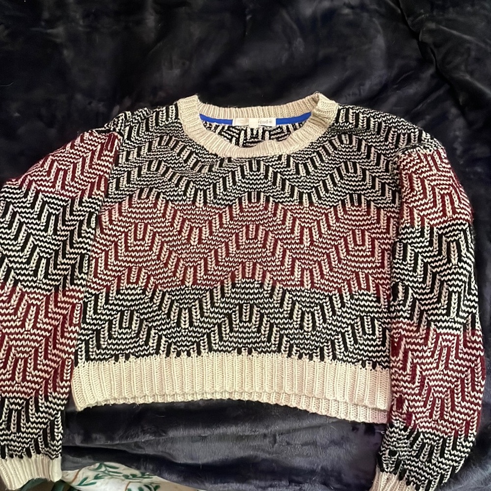 I am selling a tan, red, black zigzag striped long sleeve cropped shirt.